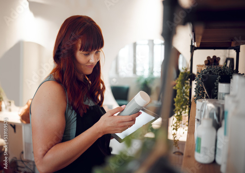 Woman in salon, product inventory on tablet and small business entrepreneur with online order in Berlin. Professional hairdresser, plastic packaging and organize beauty boutique stock with technology photo