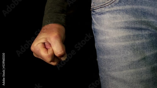 An Angry Man Clenching the Fist on black background. One Person Getting Mad and Clench the Hand Fingers in a Fist. Close up