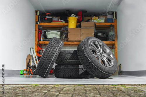 Private garage background. Car tire set in private garage.