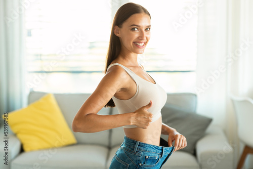 Cheerful Lady After Weight Loss Gesturing Thumbs Up At Home