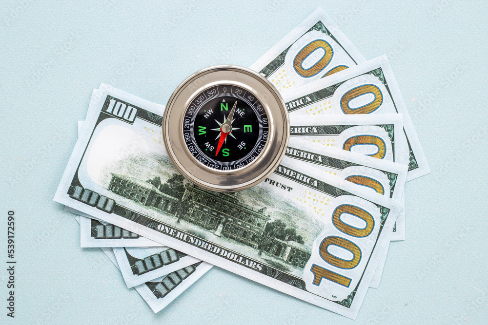 Exchange rate change concept with compass and money cash Exchange rate change concept with compass and money cash