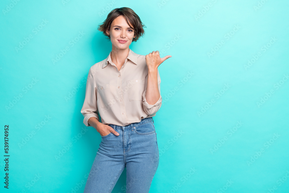 Photo of charming confident business lady hand pocket posing thumb directing empty space offer vacancy for you isolated on aquamarine color background