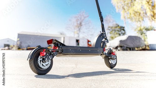 Professional electric scooter with suspension system - standing in an industrial scenery - 3d render photo