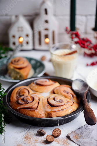 Egg nog cinnamon buns in christmas background