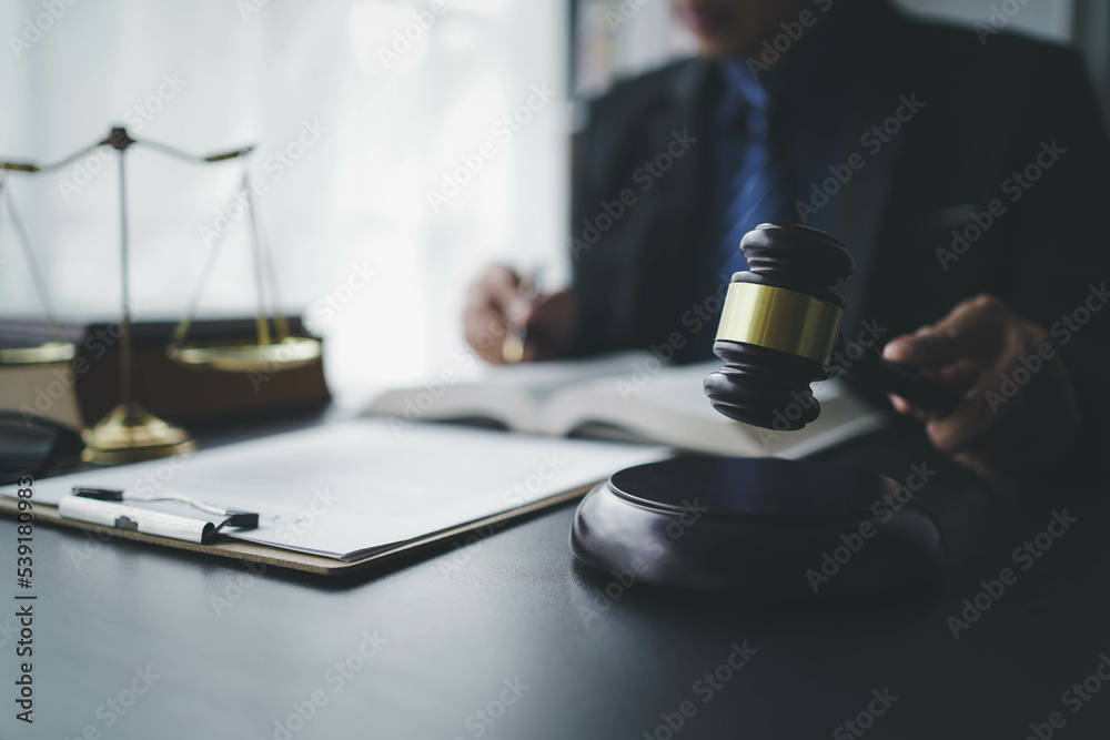 Lawyer businessmฟn working with contract papers and wooden gavel on table in courtroom. Justice and law, attorney, court judge, concept. Lawyer businessmฟn working with contract papers and wooden gavel on table in courtroom. Justice and law, attorney, court judge, concept.