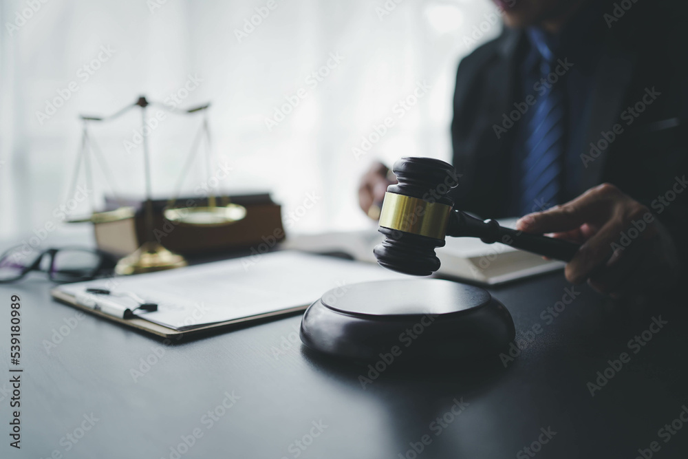 Lawyer businessmฟn working with contract papers and wooden gavel on table in courtroom. Justice and law, attorney, court judge, concept. Lawyer businessmฟn working with contract papers and wooden gavel on table in courtroom. Justice and law, attorney, court judge, concept.