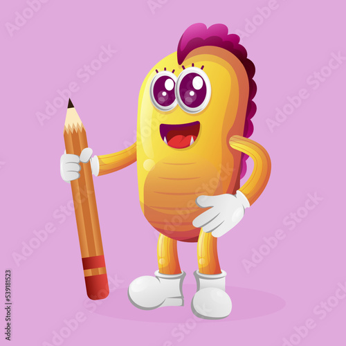 Cute yellow monster holding pencil