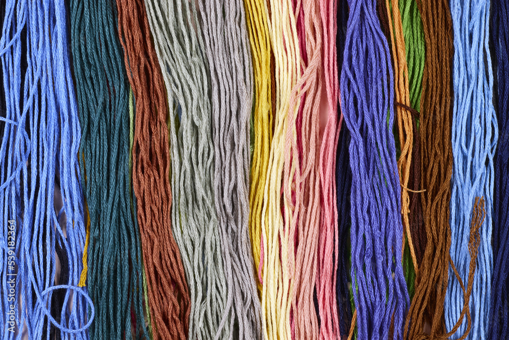 Background from various colorful threads for embroidery. Top view