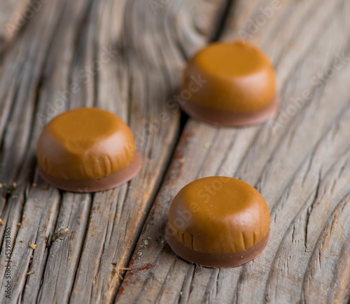 Closeup shot of caramel candies on a wooden board