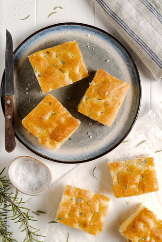 Italian focaccia on white wooden table.