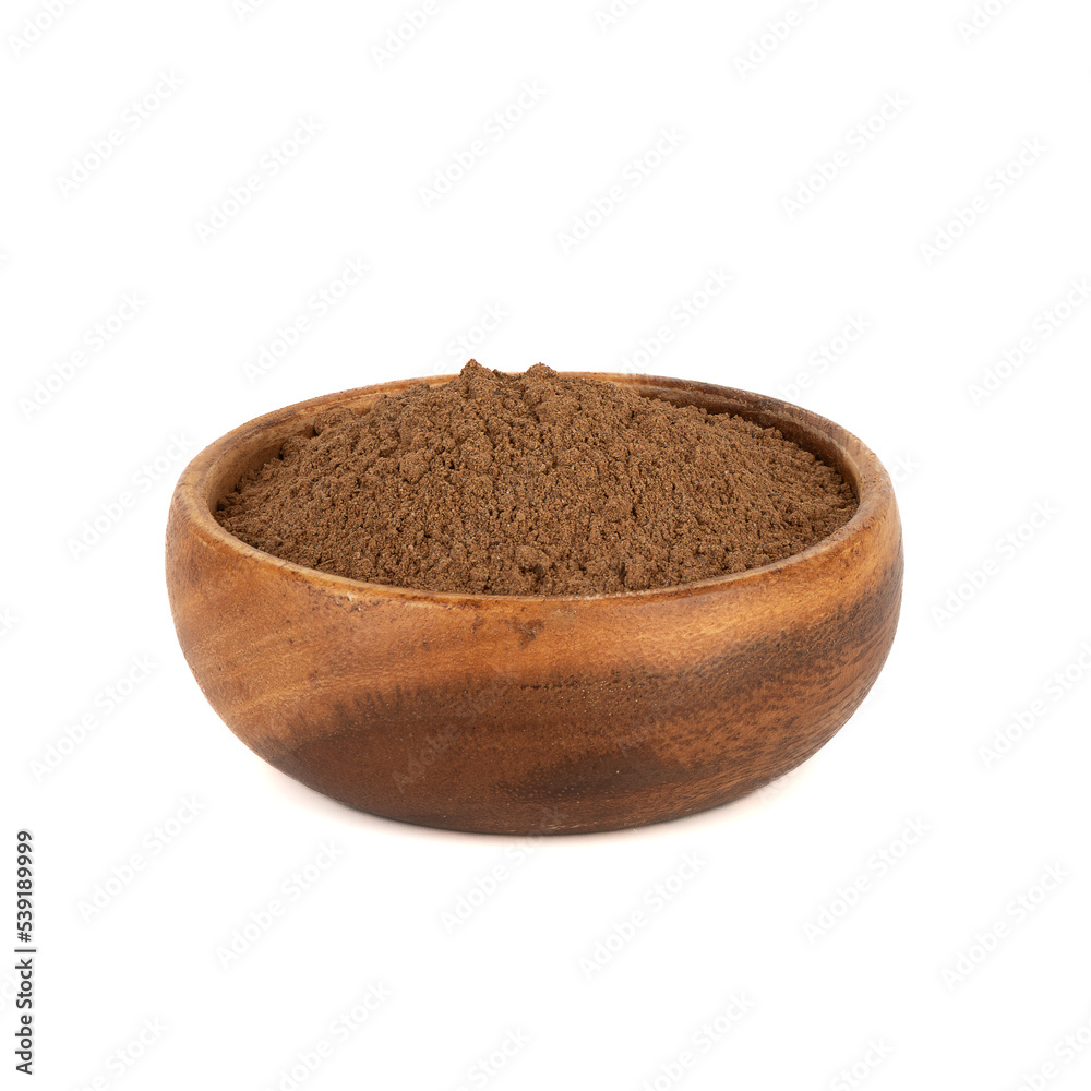 Ground cinnamon in a wooden bowl on a white background. Ground cinnamon in a wooden bowl on a white background.