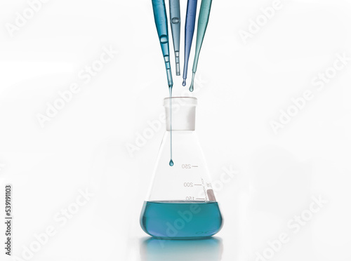 Droppers over laboratory flask placed on white surface