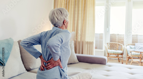 Εκτύπωση καμβά Tired upset elderly woman feeling strong lower back pain after sleeping in incorrect posture on uncomfortable mattress