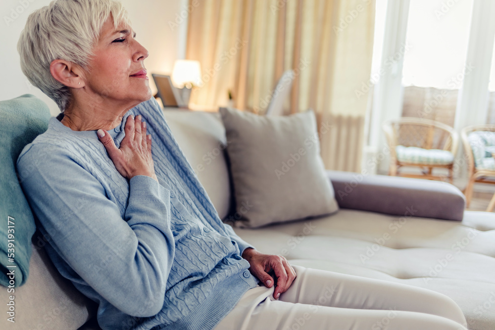 Female with chest pain. Senior woman suffering from heartburn or chest discomfort symptoms. Acid reflux or Gastroesophageal reflux disease (GERD) concept Female with chest pain. Senior woman suffering from heartburn or chest discomfort symptoms. Acid reflux or Gastroesophageal reflux disease (GERD) concept