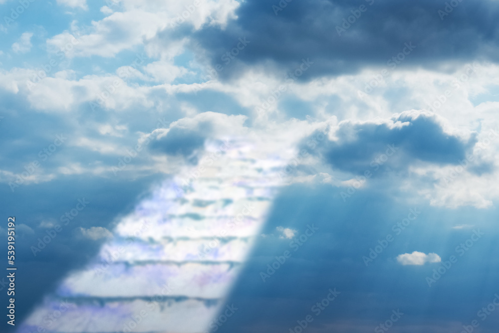 Beautiful religious background.Sunset or sunrise with clouds,stairs to heaven,bright light from heaven,stairway leading up to skies clouds.Light from sky.Religion concept.Blurred soft image.
