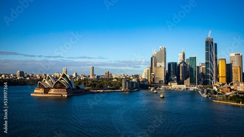 sydney skyline at sunrise  sunrise overlooking famous building and bridge in sydney, australia © Jakub
