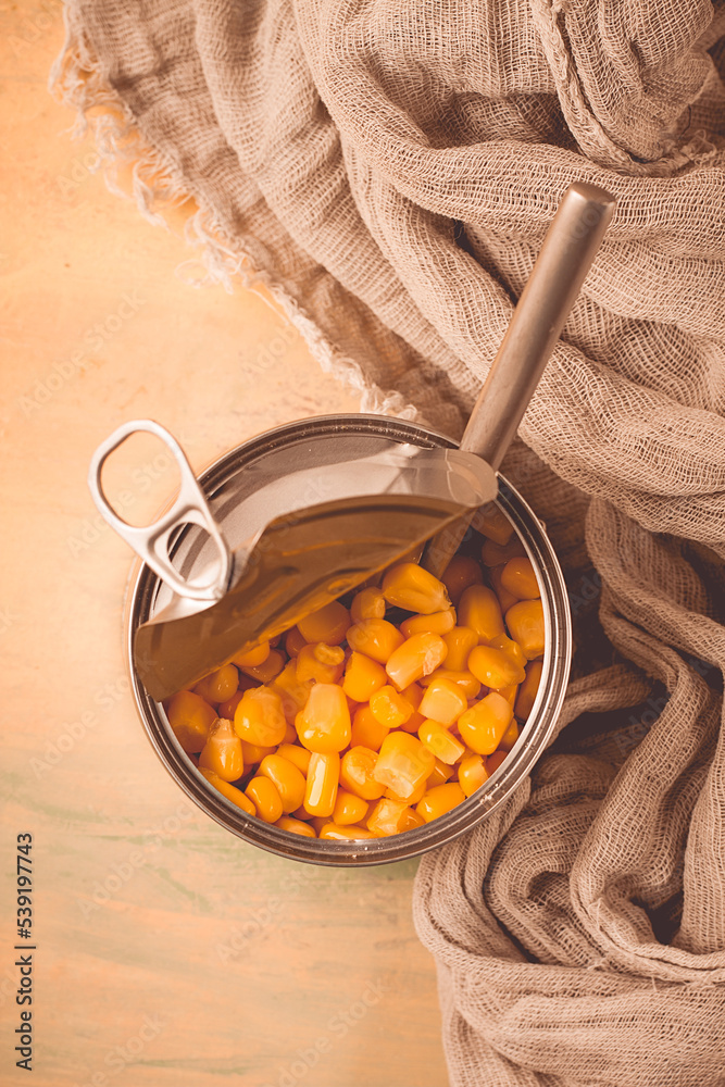 Fototapeta premium Open tin can, with corn, top view, selective focus, no people, close-up,