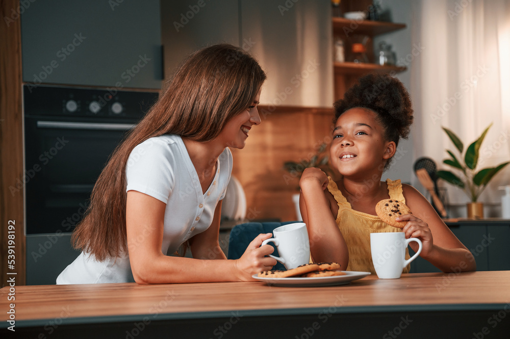 Lunch time. Young mother with her daughter is together at apartment