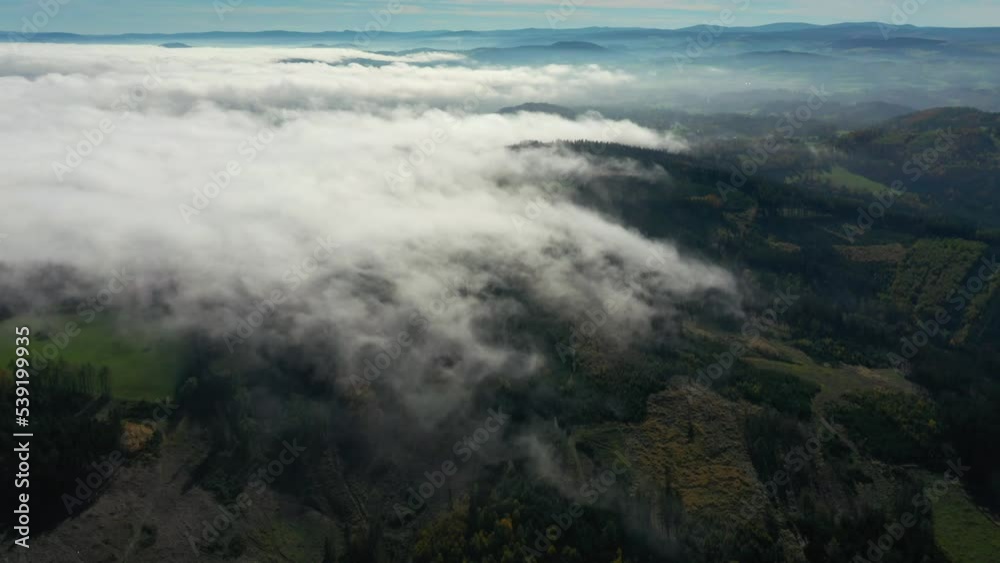 Clouds over a wooded landscape in the Bavarian borderlands. Colorful forests in autumn. Camera flight over the countryside. Climate change in Central Europe. Clouds over a wooded landscape in the Bavarian borderlands. Colorful forests in autumn. Camera flight over the countryside. Climate change in Central Europe.