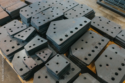 Foto Bunch of different kinds of connecting plates stacked in neat piles