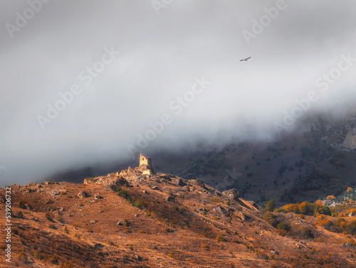Beautiful dramatic landscape nature view in the mountains. Old Ossetian battle tower in the misty mountains. Digoria region. North Ossetia, Russia.