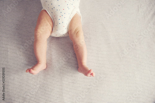 Stretched out baby legs from above