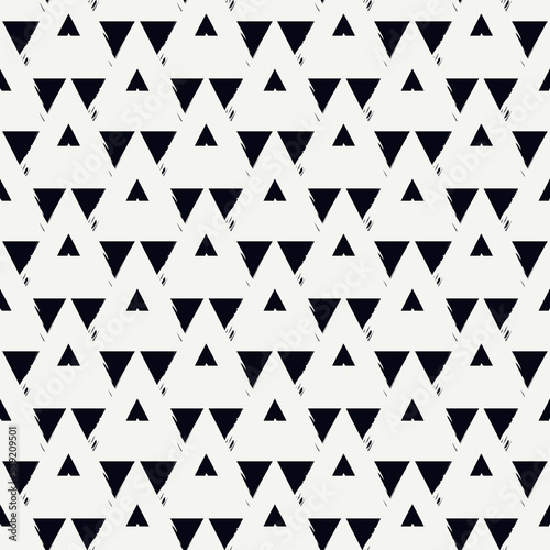 Seamless pattern. Paint brush triangles ornament. Hand drawn geometrical backdrop. Triangular shapes wallpaper. Geometric figures background. Ethnic motif. Textile print. Vector abstract.
