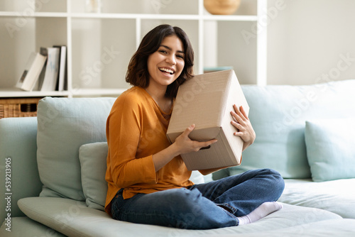 Delivery Concept. Happy Arab Woman Posing With Big Delivered Box At Home