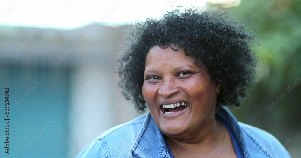 Happy diverse African woman laughing, real people smile casual Happy diverse African woman laughing, real people smile casual