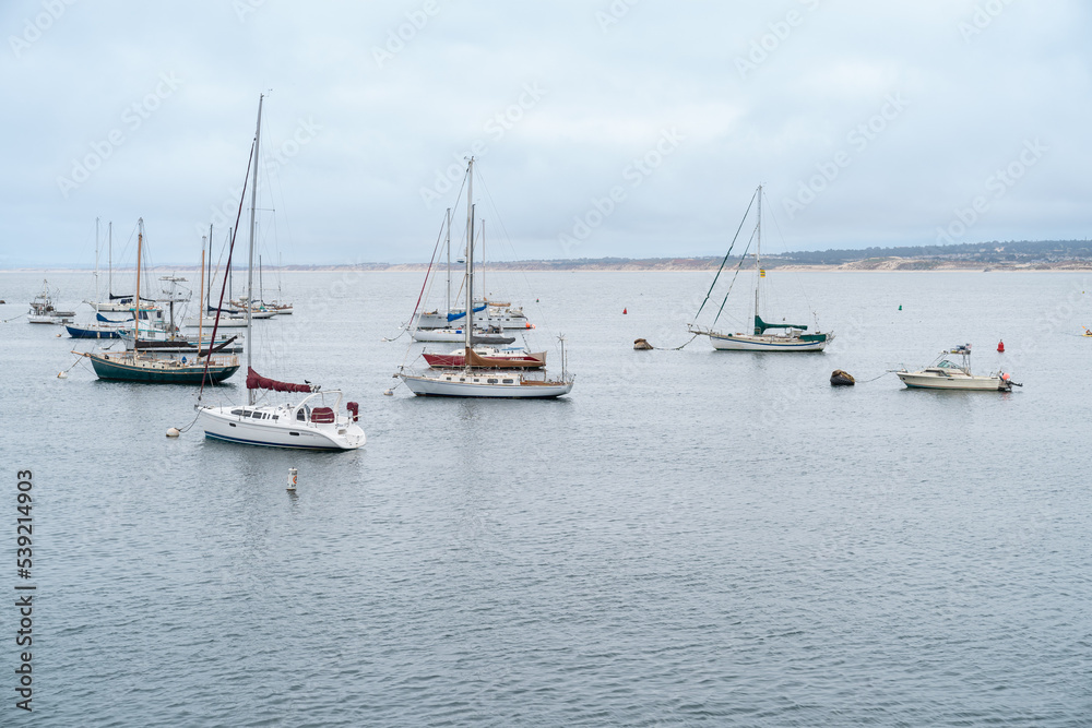 California, USA - May 18, 2018: sailing boats on the sea near old fishermanâs wharf under blue sky in the city of Monterey