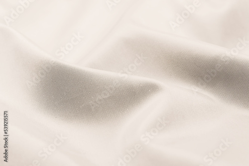 Background of white linen fabric. Texture of white material with folds