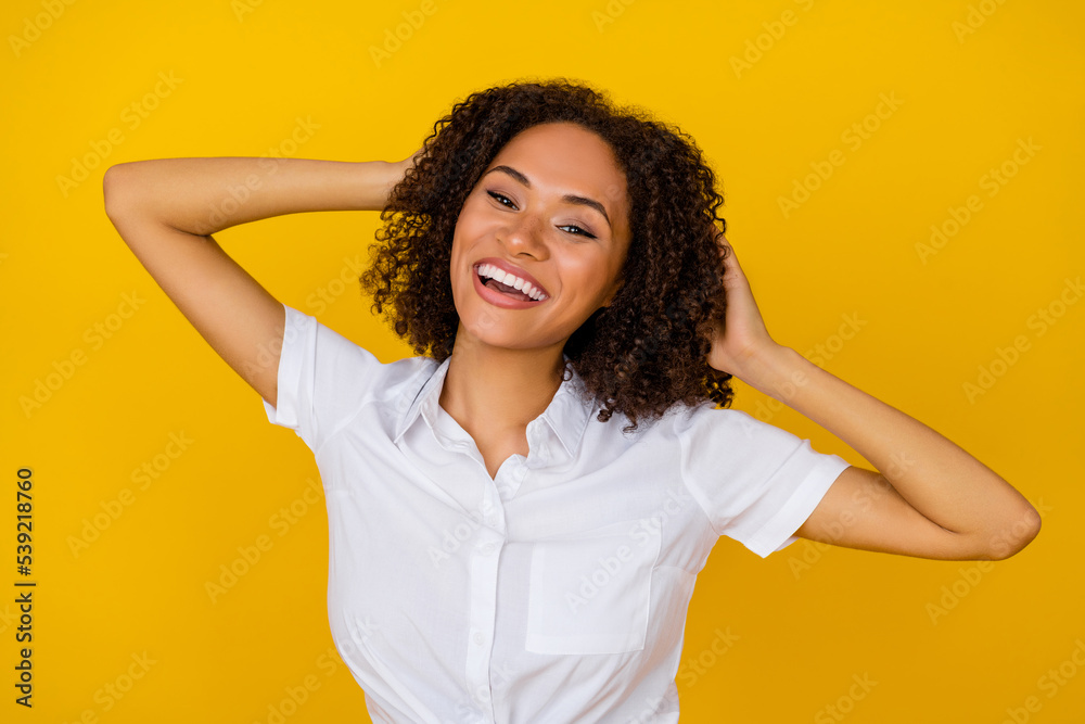 Photo of lovely wavy hairdo millennial woman touch shevelure wear white shirt isolated on yellow background Photo of lovely wavy hairdo millennial woman touch shevelure wear white shirt isolated on yellow background