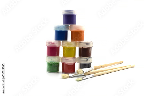 Set of watercolor paints and paintbrushes for painting closeup. Selective focus.