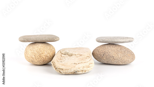 Stacks of stones on a white background, front view. Zen like concepts. Stone podium for product presentation and branding. Spa stones treatment.