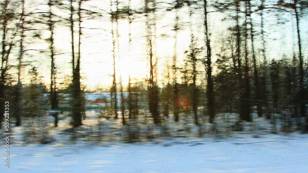 Beautiful winter nature landscape and forest on a sunset background. View from the car in motion. A lot of snow. Copy space for text Beautiful winter nature landscape and forest on a sunset background. View from the car in motion. A lot of snow. Copy space for text