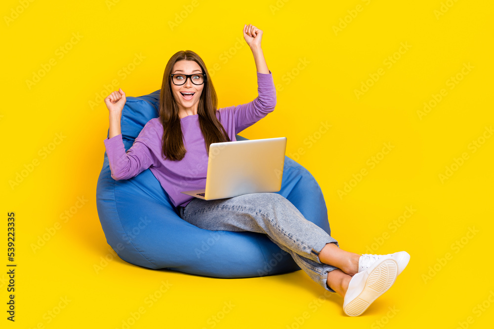 Full length photo of astonished lady sit chair rejoice career promotion success achievement empty space isolated on yellow color background Full length photo of astonished lady sit chair rejoice career promotion success achievement empty space isolated on yellow color background