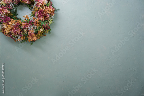 Fototapeta Naklejka Na Ścianę i Meble -  Blumenkranz auf pastellfarbenem Hintergrund
