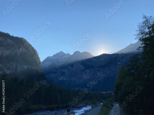Summer day blue sky mountains landscape. Nature landscape with sun and blue sky. Summer travel in Europe mountains. Nature, lake, forest, trees hiking path. Clouds on blue sky. Forest landscape hiking