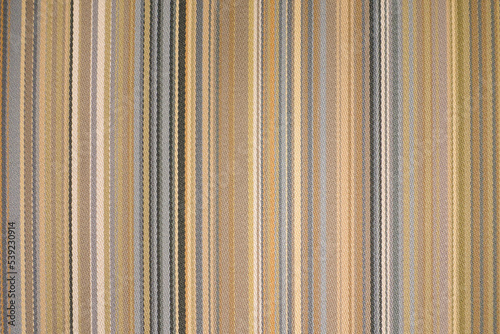 colorful earth tone fabric background with soft faded rainbow-colored vertical stripes