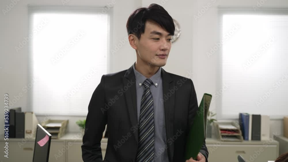 portrait of successful male ceo wearing suit walking and looking with paperwork folder, feeling pleased about everyone working hard in the office. good leadership concept portrait of successful male ceo wearing suit walking and looking with paperwork folder, feeling pleased about everyone working hard in the office. good leadership concept