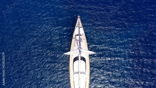 Aerial drone photo of beautiful sail boat anchored in deep blue open ocean sea © aerial-drone