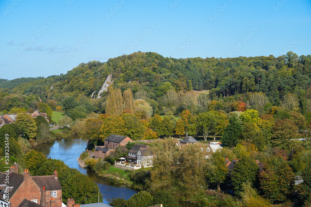 A view of low town in Bridgnorth over the River Severn with Autumn coloured foliage