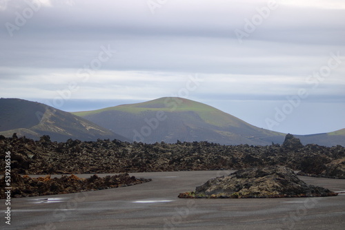 vulcanic landscape with vulcanos and craters on lanzarote, canary islands, spain photo