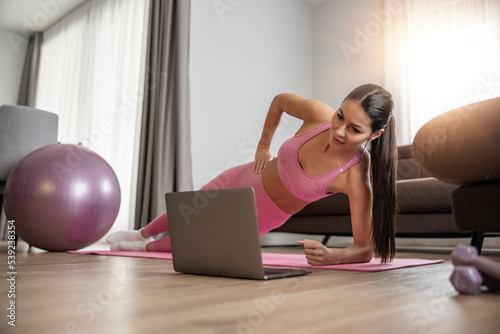 Attractive woman exercising at home
