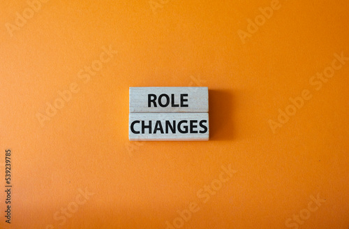 Role changes symbol. Concept words Role changes on wooden blocks. Beautiful orange background. Business and Role changes concept. Copy space.