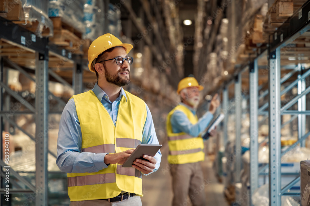 Man warehouse worker with a tablet Man warehouse worker with a tablet