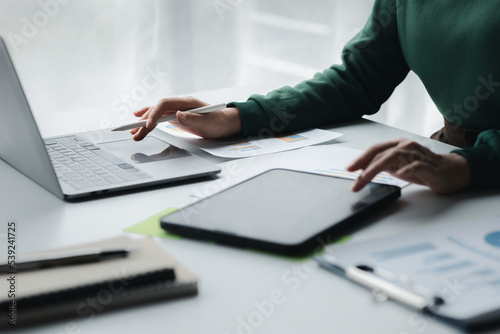 Business men are looking at the company s financial documents on tablets to analyze problems and find solutions before bringing the information to a meeting with a partner. Financial concept.