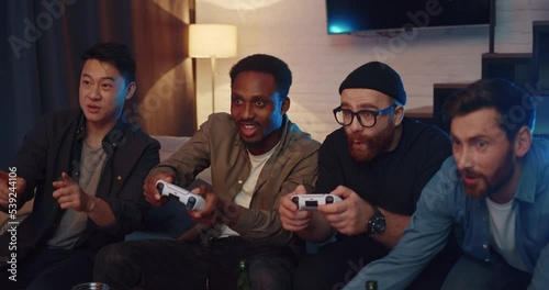 Men friends having fun playing video games and competing
