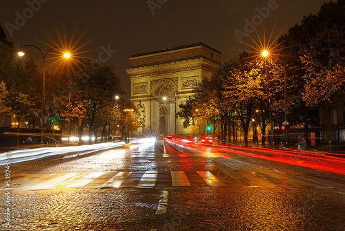 The Triumphal Arch in rainy evening, Paris, France. © kovalenkovpetr