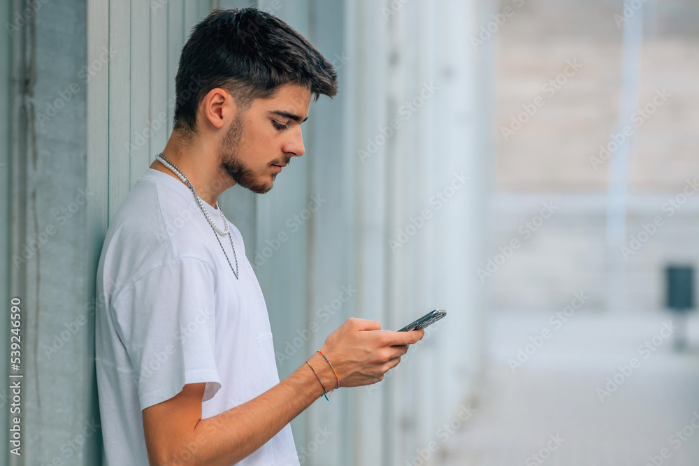 millennial on the street with mobile phone millennial on the street with mobile phone